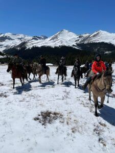 Three Peak Outfitters flatbush alberta riding horses in valley beside mountain